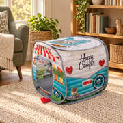 KONG pop-up camper on a cream rug beside a reading chair