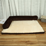 Coffee corduroy bed with two raised sides and a cream sleeping surface